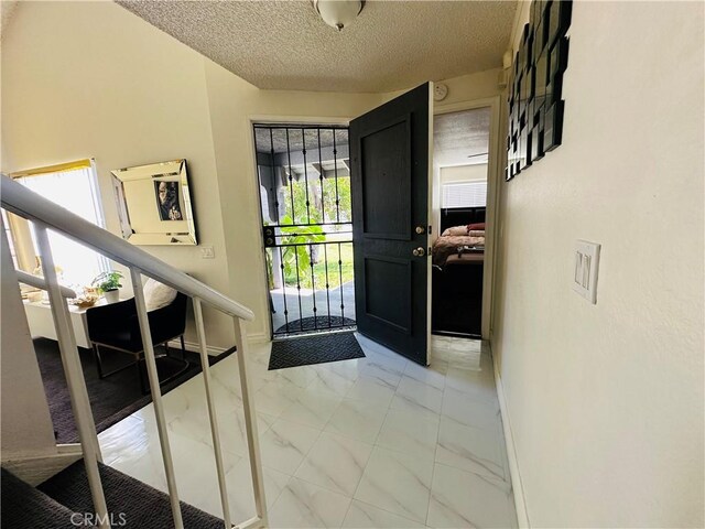 entryway with a textured ceiling