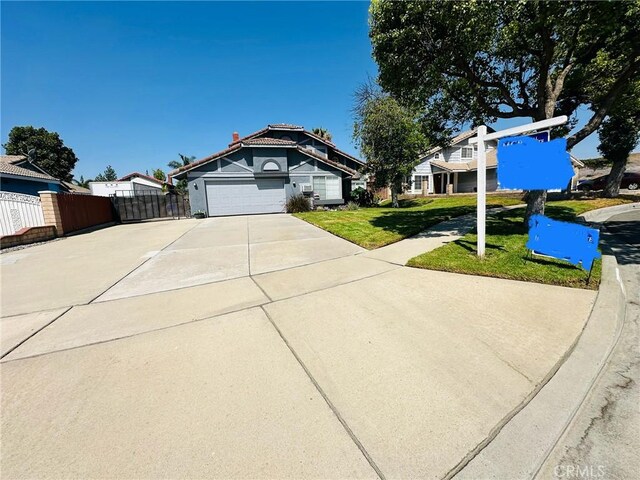 view of front facade featuring a garage and a front lawn