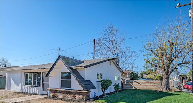 exterior space with a yard and a garage