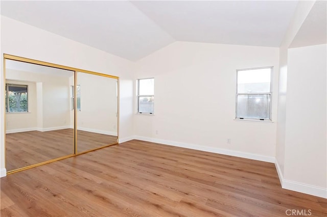 unfurnished bedroom featuring hardwood / wood-style floors and multiple windows