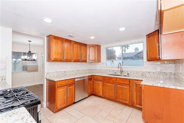 kitchen featuring stove, tasteful backsplash, sink, decorative light fixtures, and dishwasher