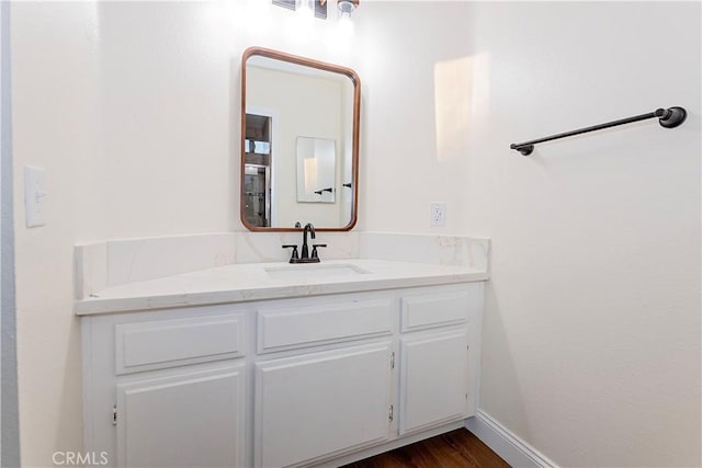 bathroom featuring hardwood / wood-style flooring and vanity