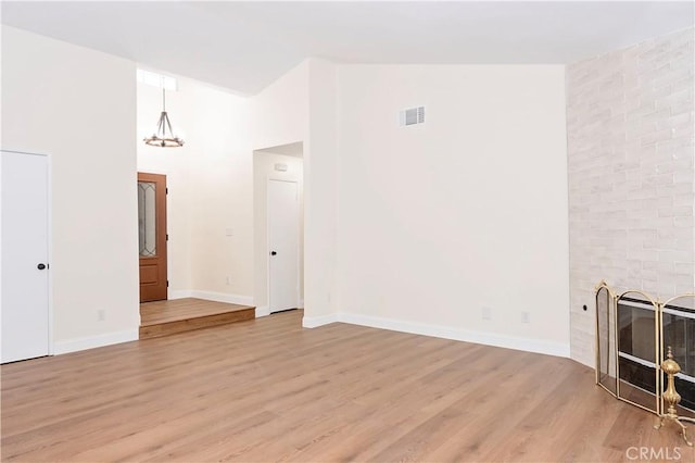 living room featuring a fireplace, high vaulted ceiling, and hardwood / wood-style flooring