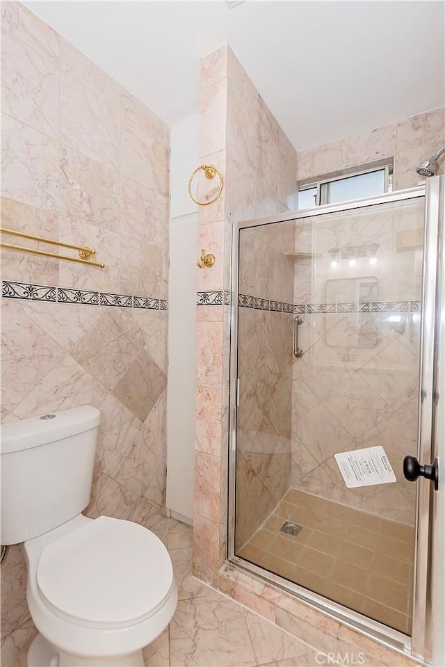 bathroom with walk in shower, toilet, and tile walls