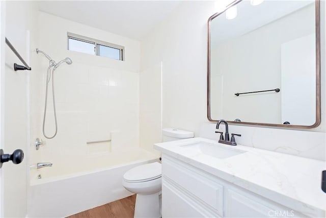 full bathroom featuring hardwood / wood-style flooring, vanity, toilet, and bathtub / shower combination