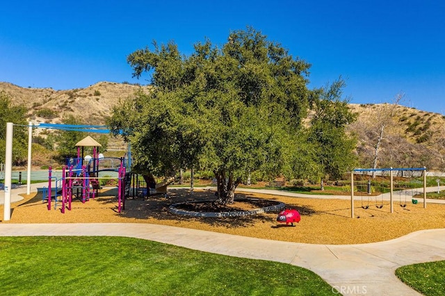 view of jungle gym featuring a mountain view