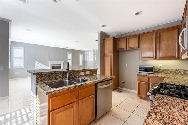 kitchen featuring plenty of natural light, sink, appliances with stainless steel finishes, and an island with sink