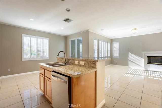 kitchen featuring light stone counters, stainless steel dishwasher, a kitchen island with sink, sink, and light tile patterned flooring