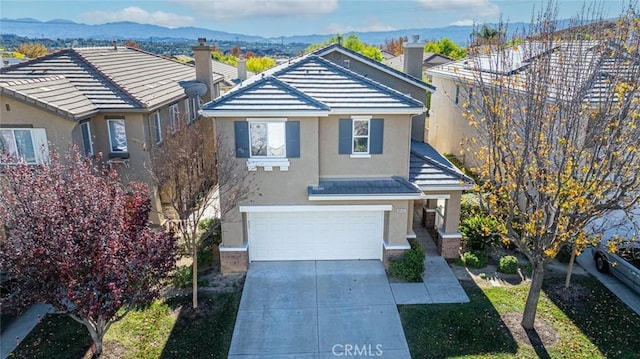 view of property featuring a mountain view and a garage