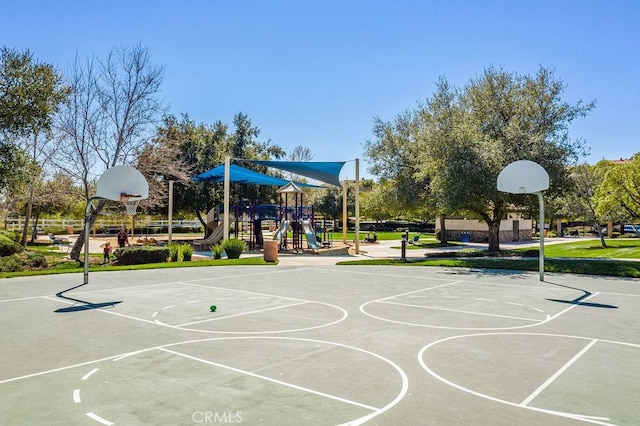 view of basketball court featuring a playground