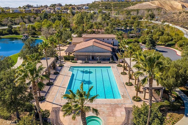 view of swimming pool with a water view