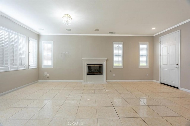 unfurnished living room with a wealth of natural light, light tile patterned floors, a chandelier, and ornamental molding