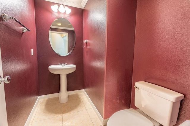 bathroom featuring tile patterned flooring, toilet, and ornamental molding