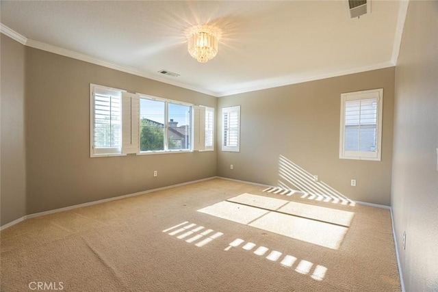 empty room featuring light carpet, ornamental molding, and a notable chandelier