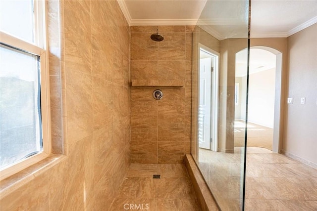 bathroom featuring a tile shower and ornamental molding