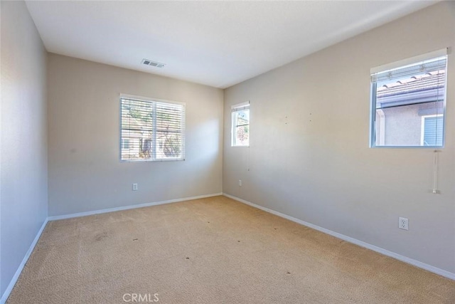 empty room featuring light colored carpet