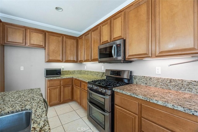 kitchen featuring light tile patterned floors, stainless steel appliances, light stone counters, and crown molding