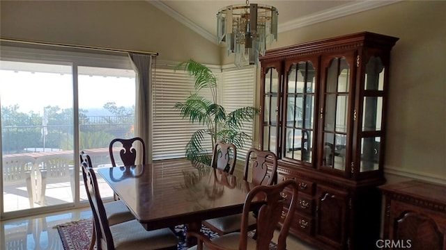 dining room with lofted ceiling, an inviting chandelier, and crown molding