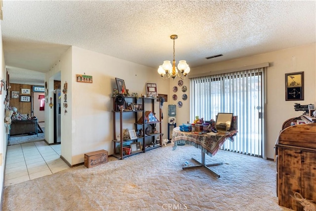 carpeted dining room with an inviting chandelier and a textured ceiling