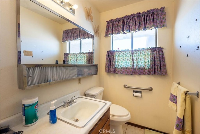 bathroom featuring vanity, tile patterned floors, and toilet