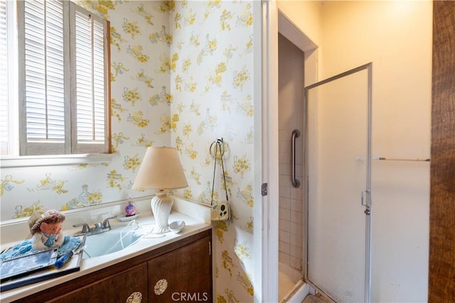 bathroom featuring sink, walk in shower, and plenty of natural light