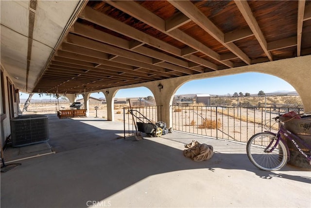 view of patio / terrace with central AC and a rural view