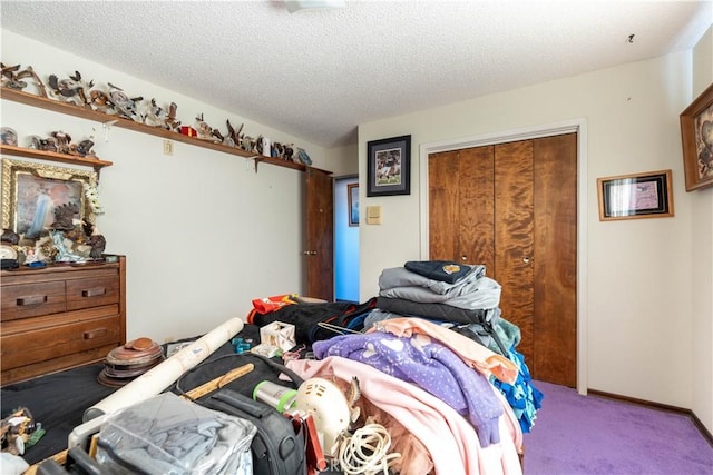 bedroom with carpet, a closet, and a textured ceiling