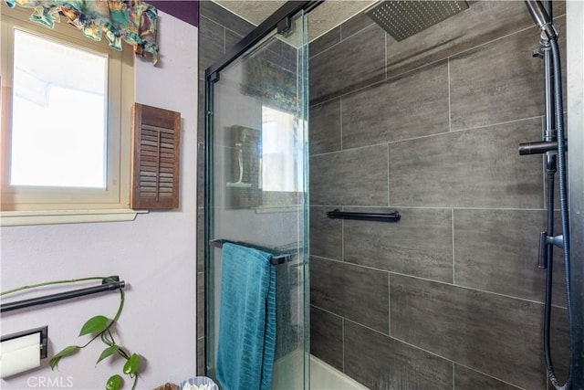 bathroom with plenty of natural light and a shower with shower door