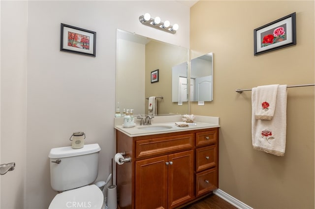 bathroom featuring vanity and toilet