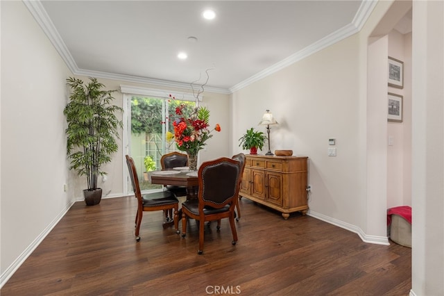 dining room featuring dark hardwood / wood-style floors and ornamental molding