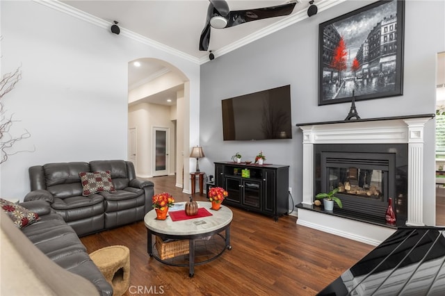 living room featuring dark hardwood / wood-style flooring, ceiling fan, and ornamental molding