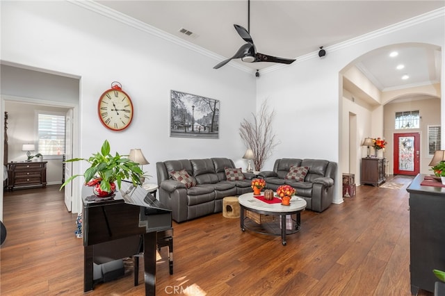 living room featuring ceiling fan, ornamental molding, and dark wood-type flooring