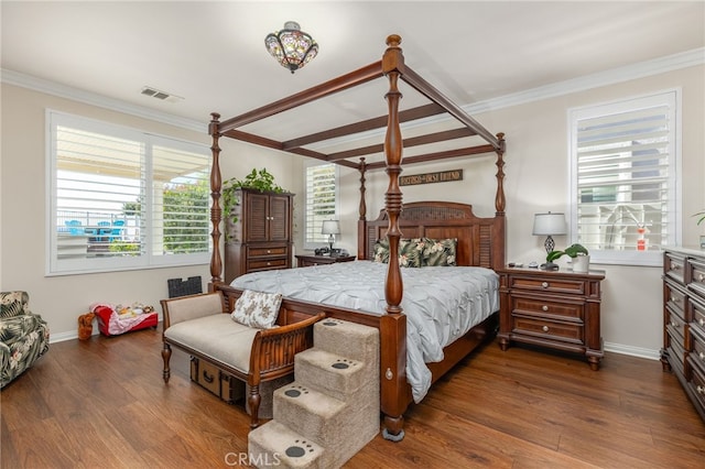 bedroom with crown molding and dark wood-type flooring