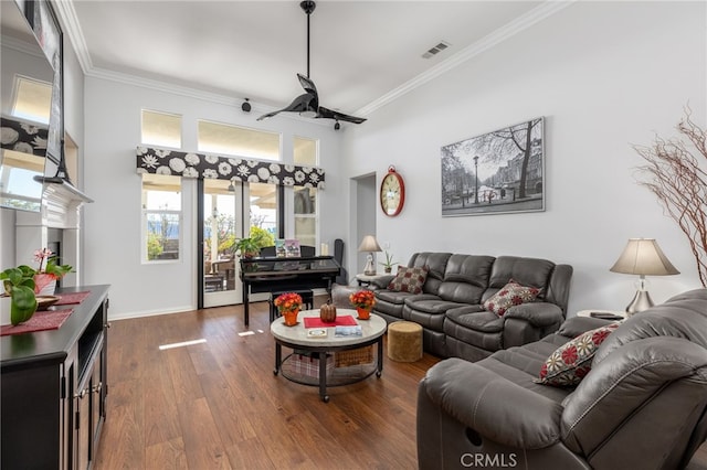 living room featuring ceiling fan, ornamental molding, and hardwood / wood-style flooring