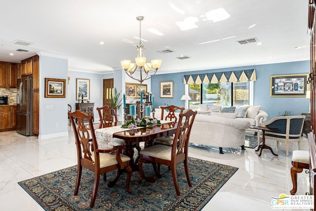 dining space with crown molding and an inviting chandelier