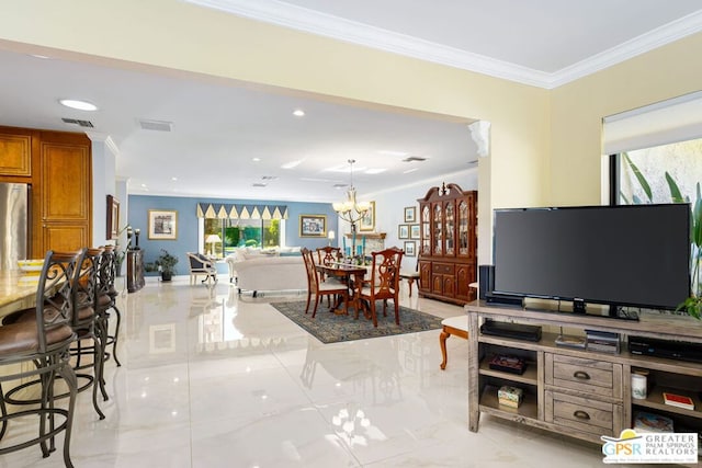 living room featuring an inviting chandelier and ornamental molding