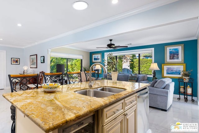 kitchen featuring light stone countertops, sink, beverage cooler, crown molding, and a center island with sink