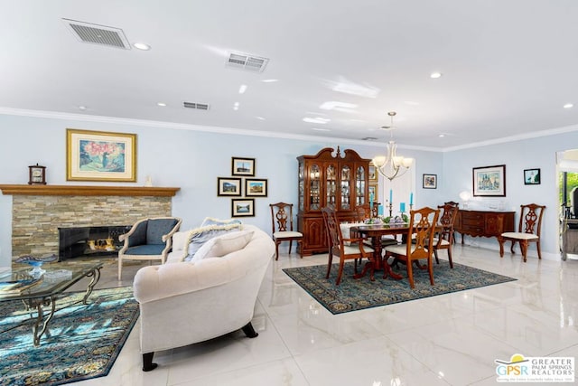 dining space with a stone fireplace, crown molding, and an inviting chandelier