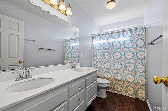 bathroom with hardwood / wood-style floors, vanity, curtained shower, and toilet