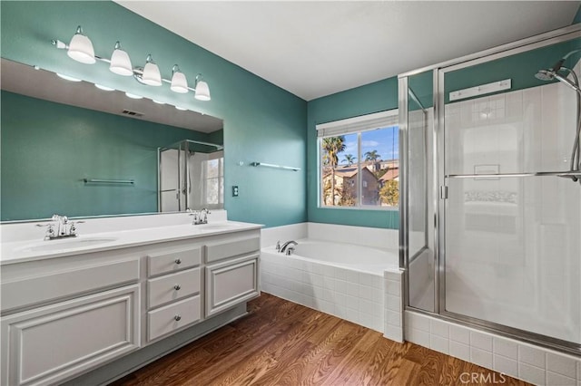 bathroom featuring vanity, hardwood / wood-style flooring, and independent shower and bath