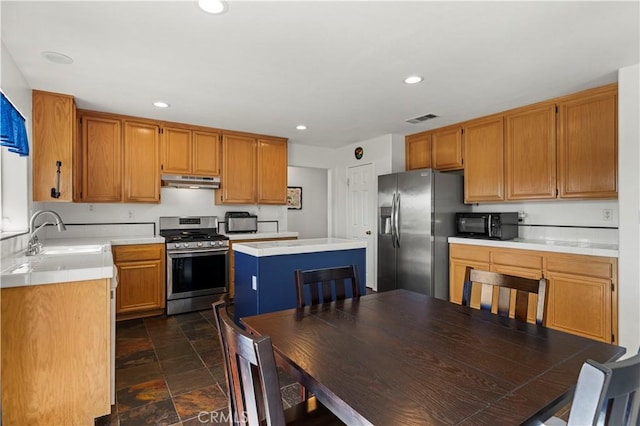 kitchen featuring a kitchen island, sink, and appliances with stainless steel finishes