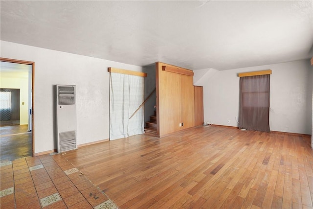 unfurnished living room with hardwood / wood-style flooring and a wealth of natural light