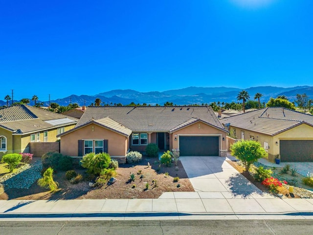 ranch-style home with a mountain view and a garage