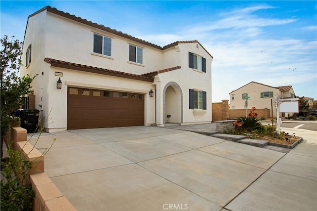 mediterranean / spanish-style home with a garage