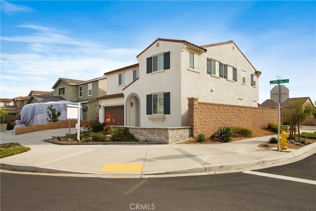 mediterranean / spanish-style home featuring a garage