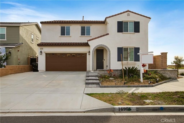 mediterranean / spanish home featuring a garage