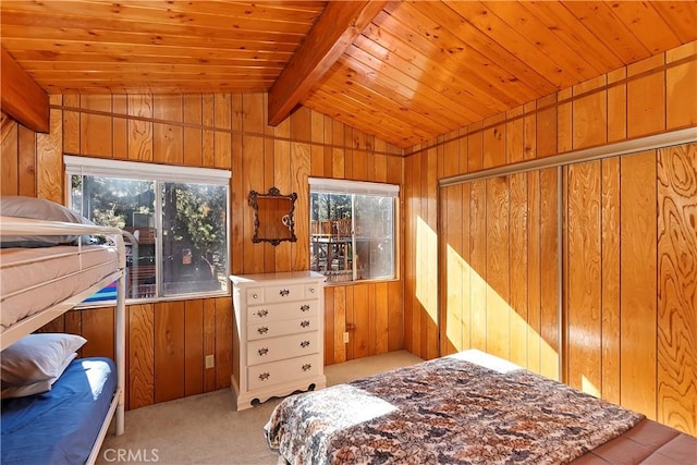 bedroom featuring vaulted ceiling with beams, multiple windows, and wood walls