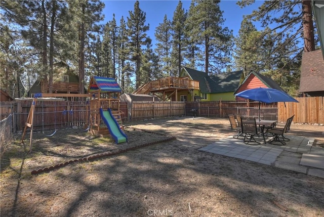 view of playground featuring a patio area