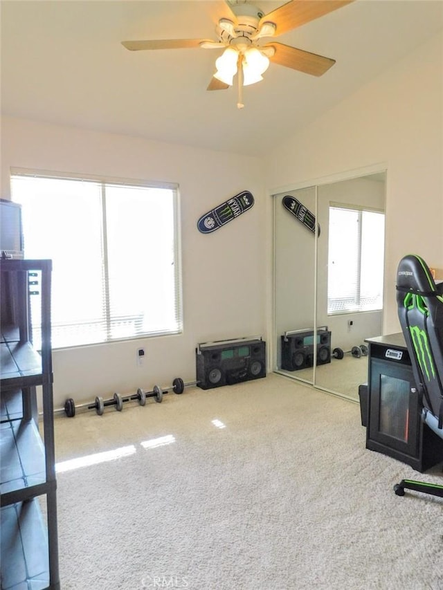 carpeted office with plenty of natural light, ceiling fan, and vaulted ceiling