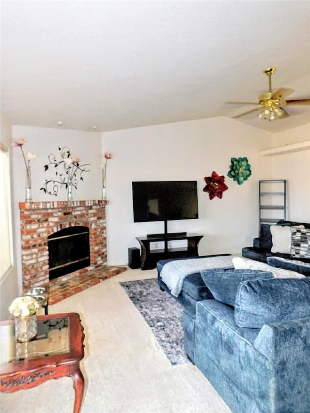 carpeted living room featuring ceiling fan and a fireplace